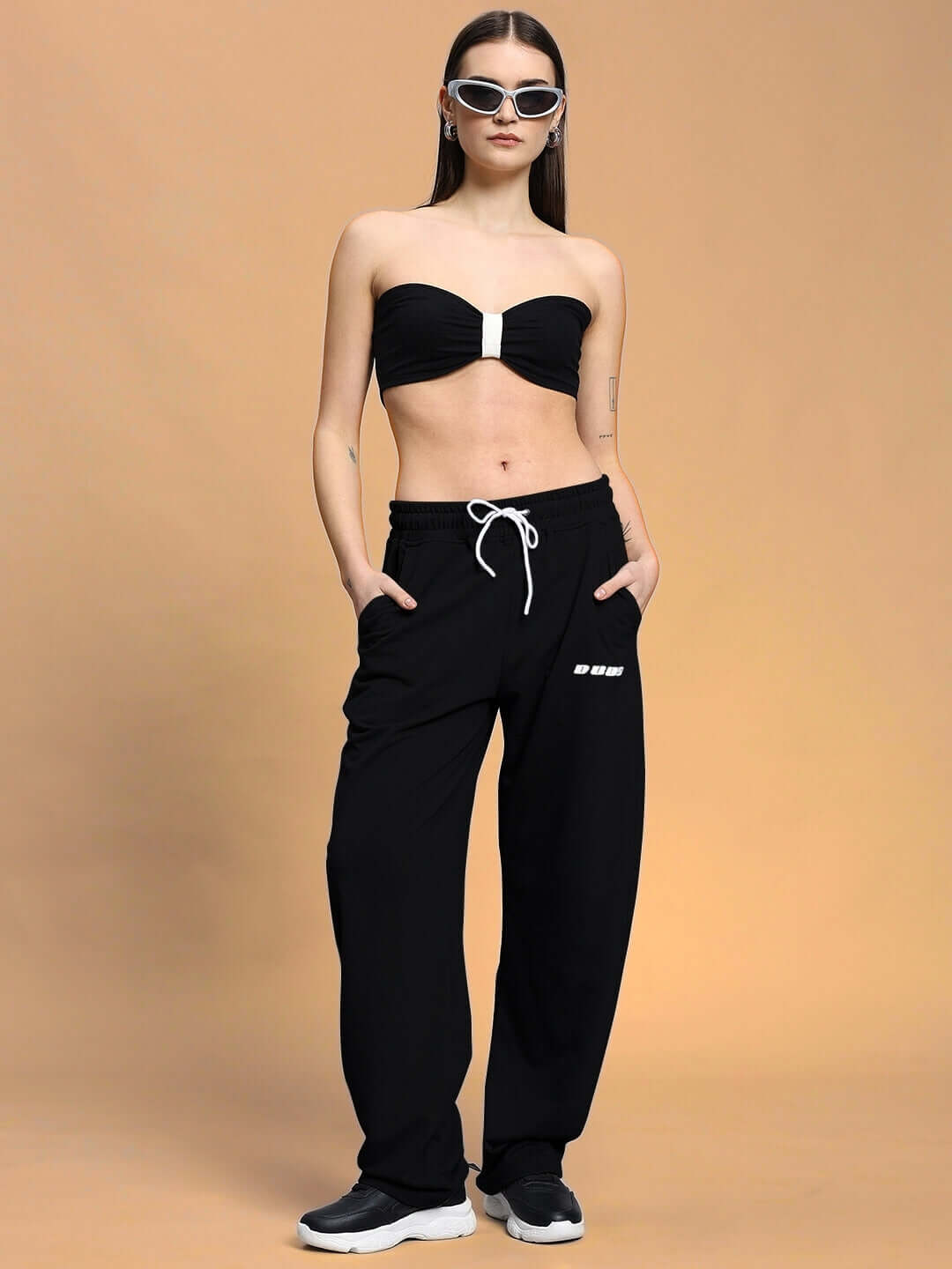 Model wearing Women's Lia Co-Ord Set in black with joggers made of 97% cotton and 3% elastane, featuring elasticated waistband.