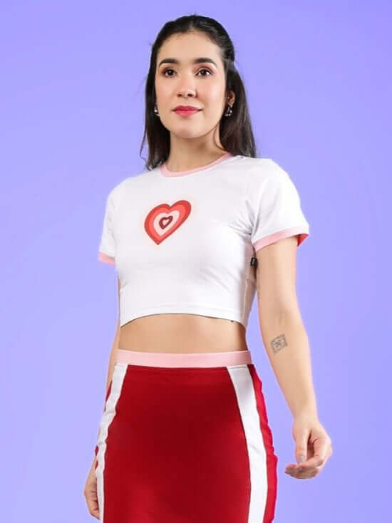 Model wearing Women's Libi Heart Crop Top in white with heart design, made of French Terry Lycra, perfect for casual wear.