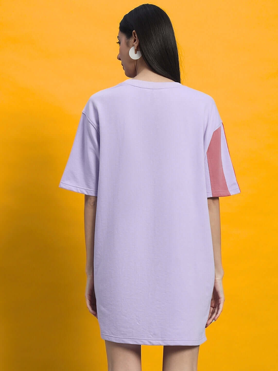 Back view of WOMEN'S PEACH PUFF DRESS LILAC on model against yellow background