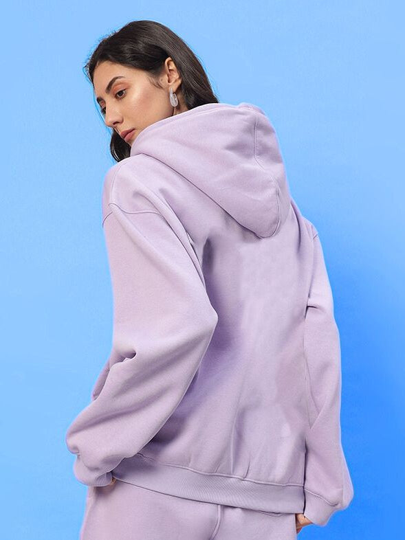 WOMENS SILENT HUG PRINTED FLEECE HOODIE LILAC shown in dreamy lilac hue, highlighting soft comfort and modern style on model.
