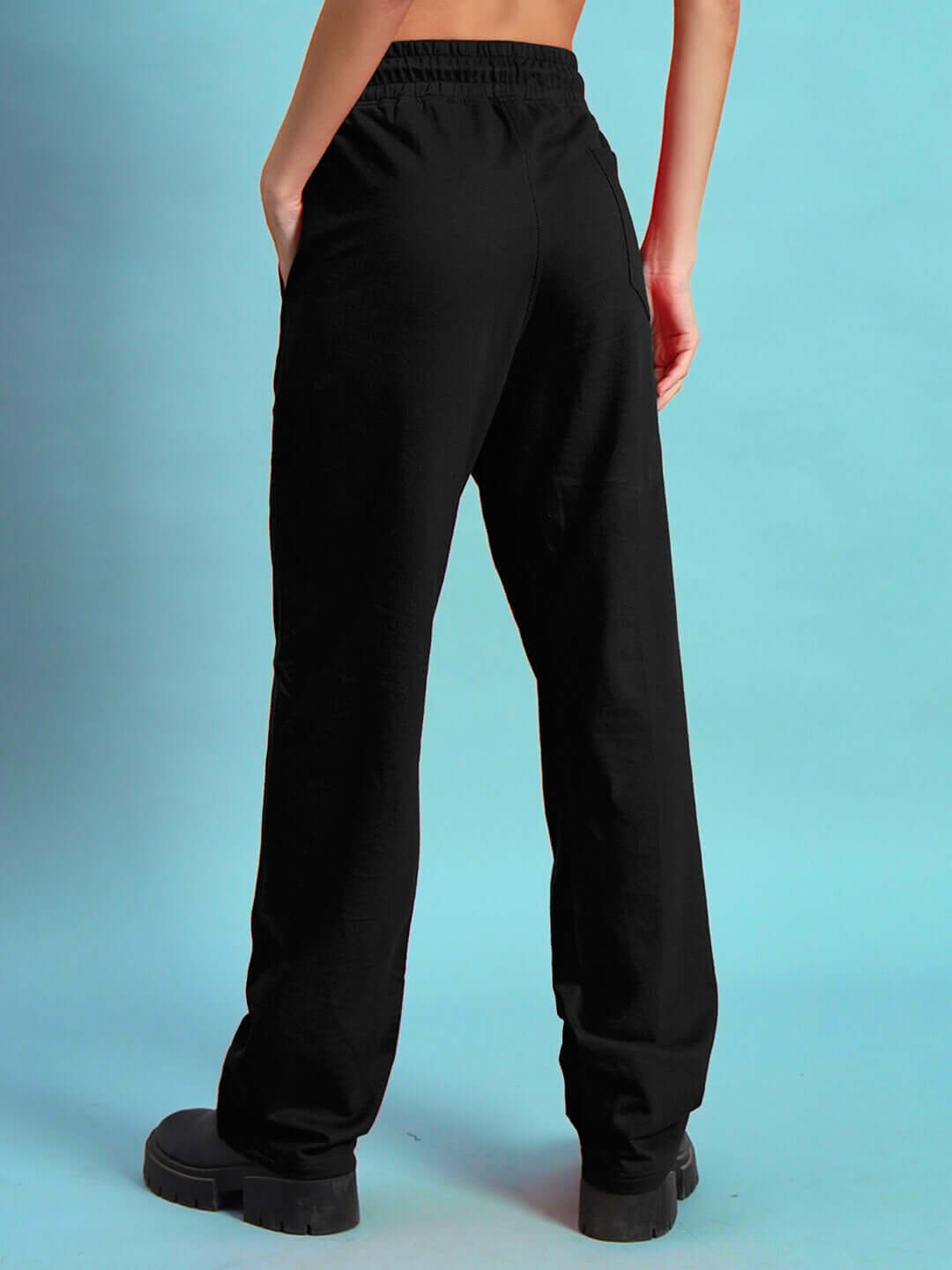 Back view of Women's DUDS Limited Edition Black Jogger, showcasing relaxed fit and sleek design against a blue background.