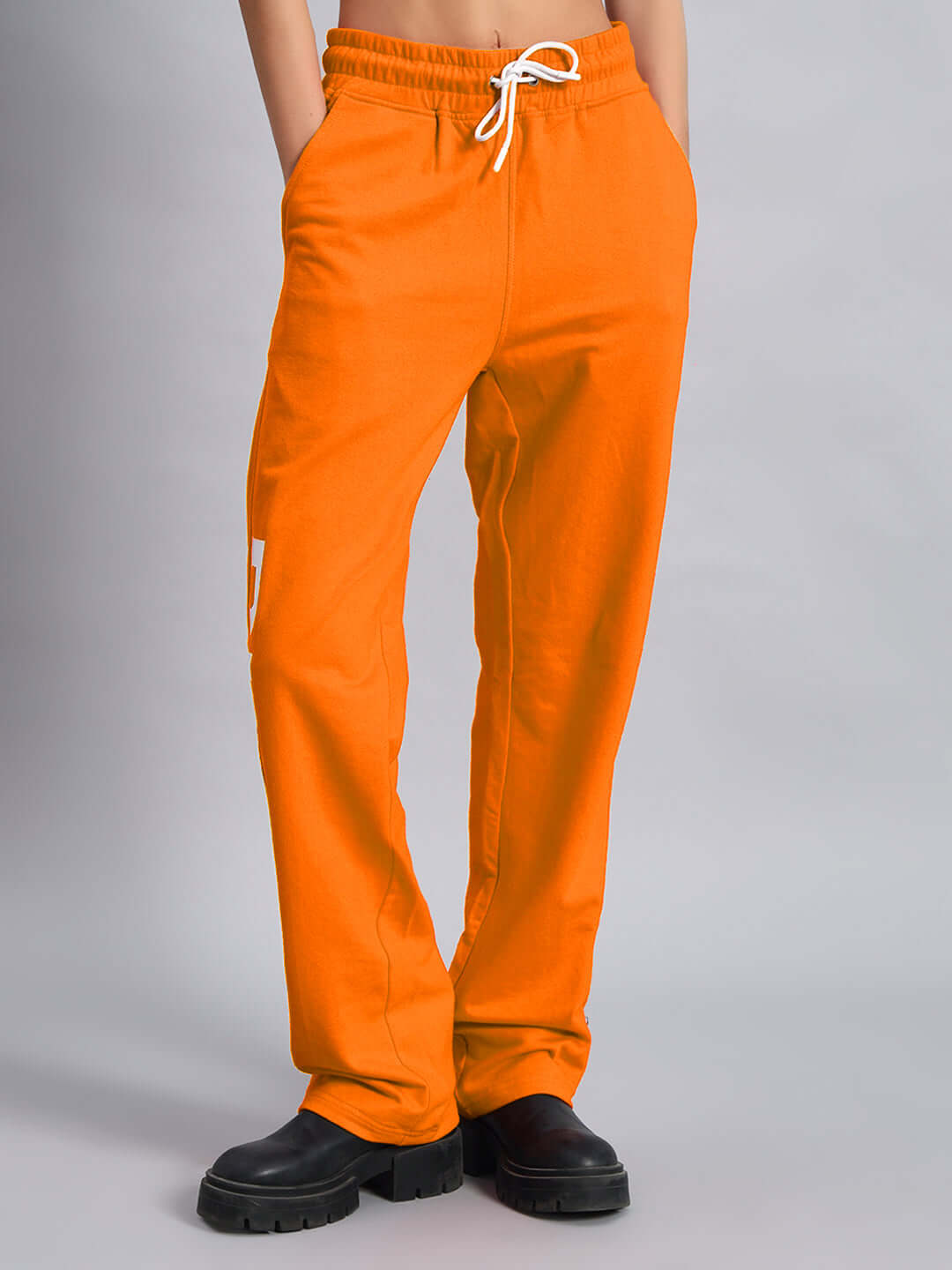 WOMEN'S DUDS LIMITED EDITION JOGGER ORANGE displayed with black shoes.
