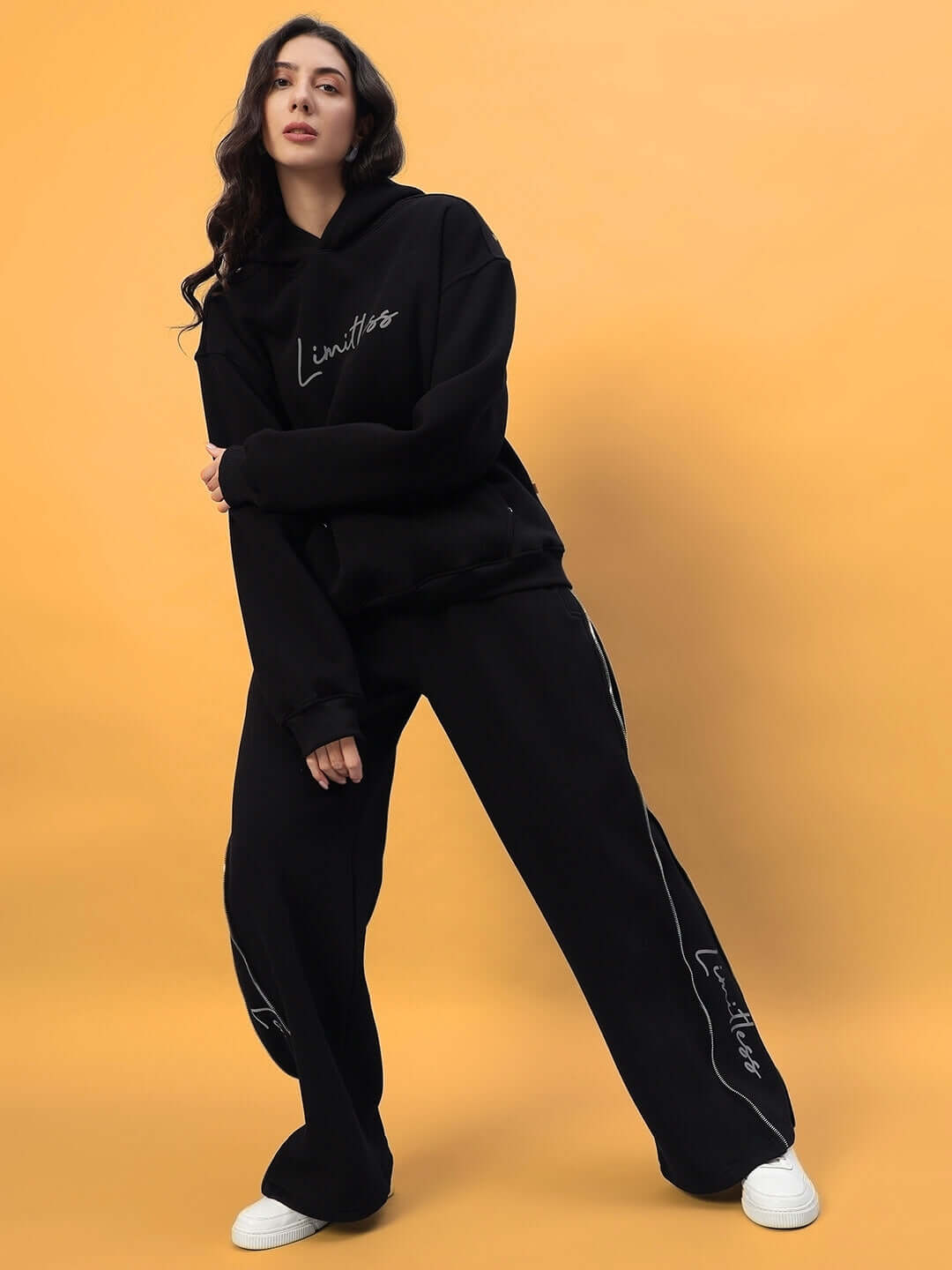 Woman wearing Women's Limitless Fleece Reflector Co-ord in black, featuring stylish design and comfortable fit, perfect for casual wear.