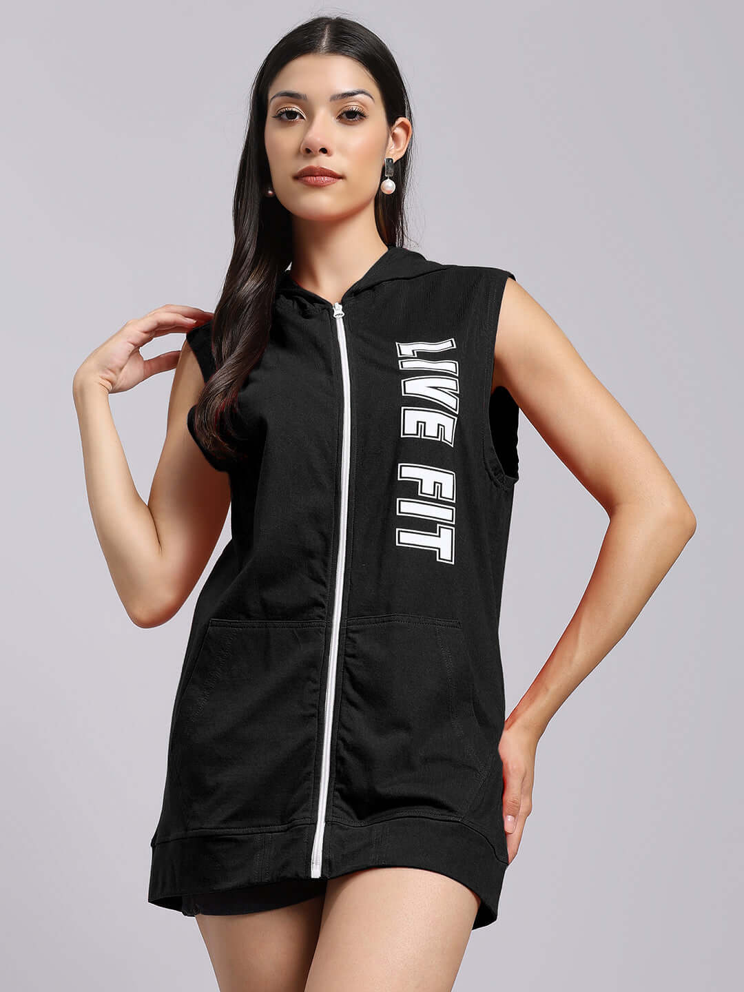 Model wearing WOMEN'S LIVE FIT GYM HOODED T-SHIRT BLACK, showcasing sleeveless design with zipper for activewear style and comfort.
