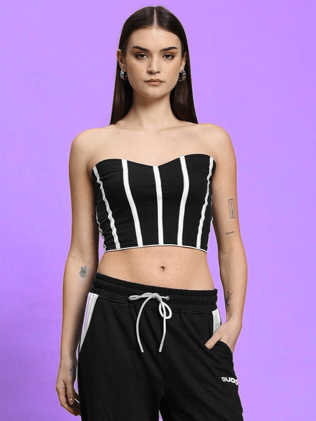 Model wearing Women's Liviana Cool Bandeau Top in black with vertical stripes, made from premium cotton, on a purple background.