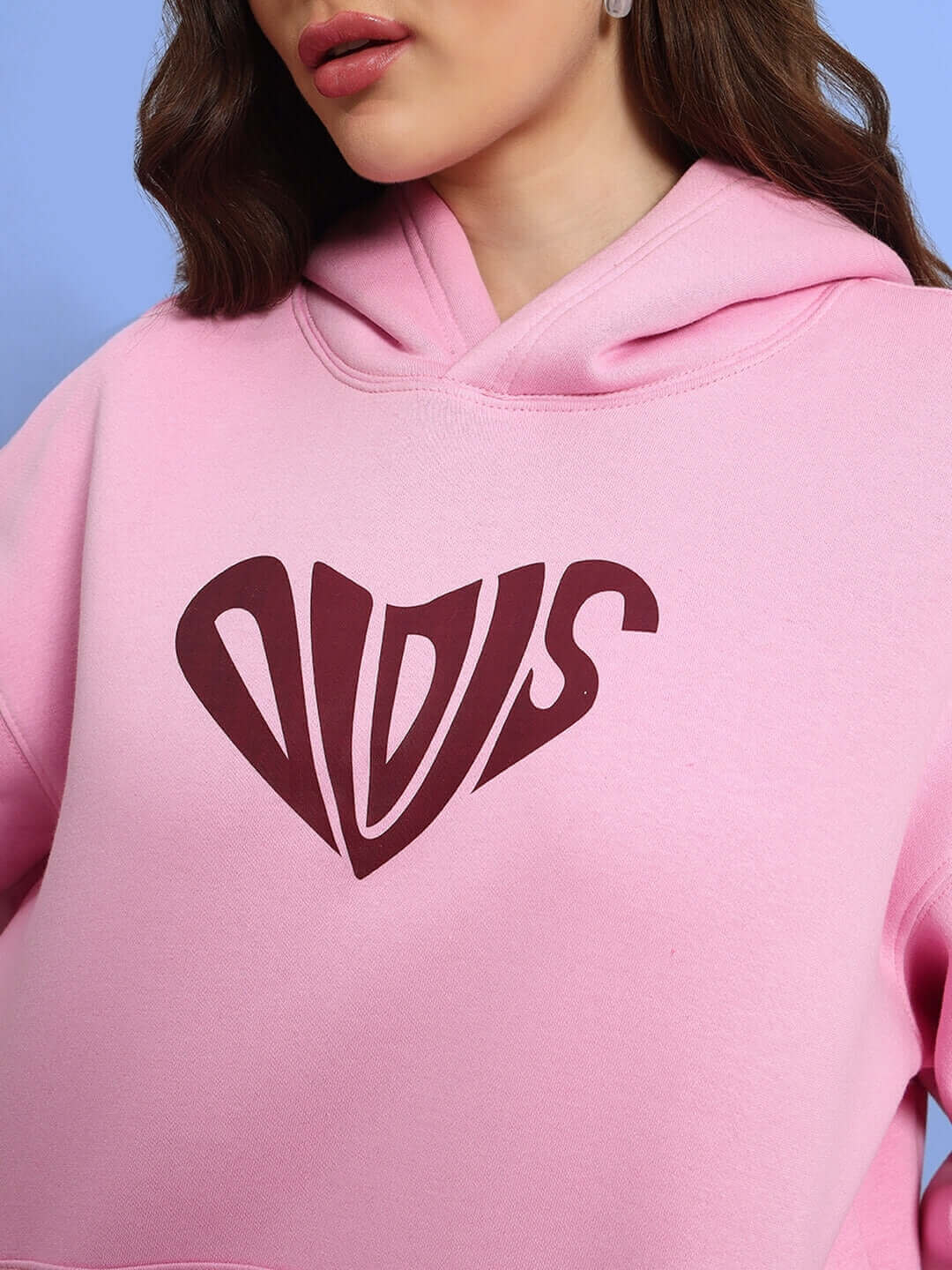 Close-up of WOMEN LOVERS CLUB FLEECE HOODIE PINK with unique heart design, showcasing modern style and comfort.