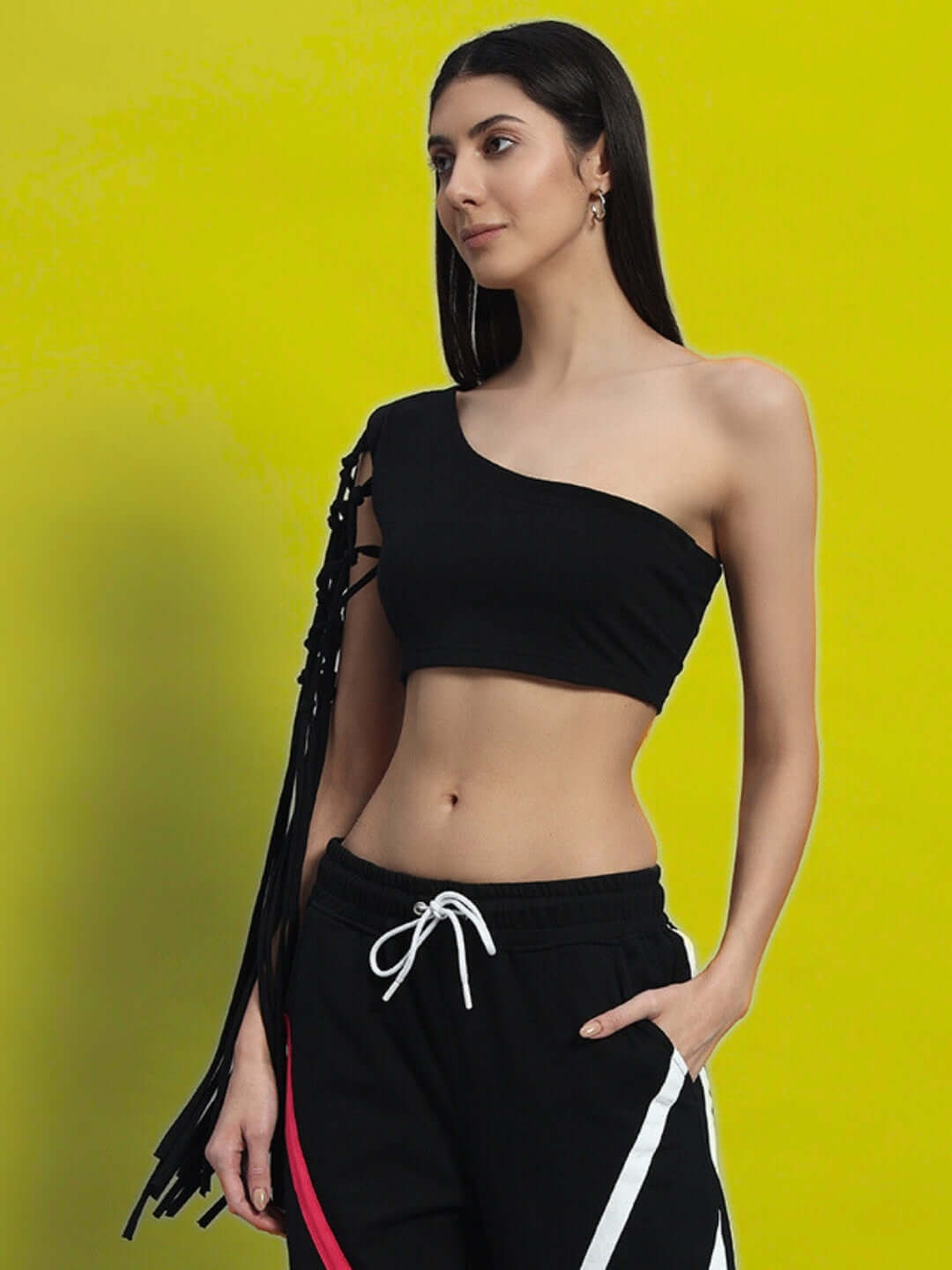 Fashionable black women's macrame crop top on model, one-shoulder design with fringe detail, made of premium cotton lycra. Shop online.