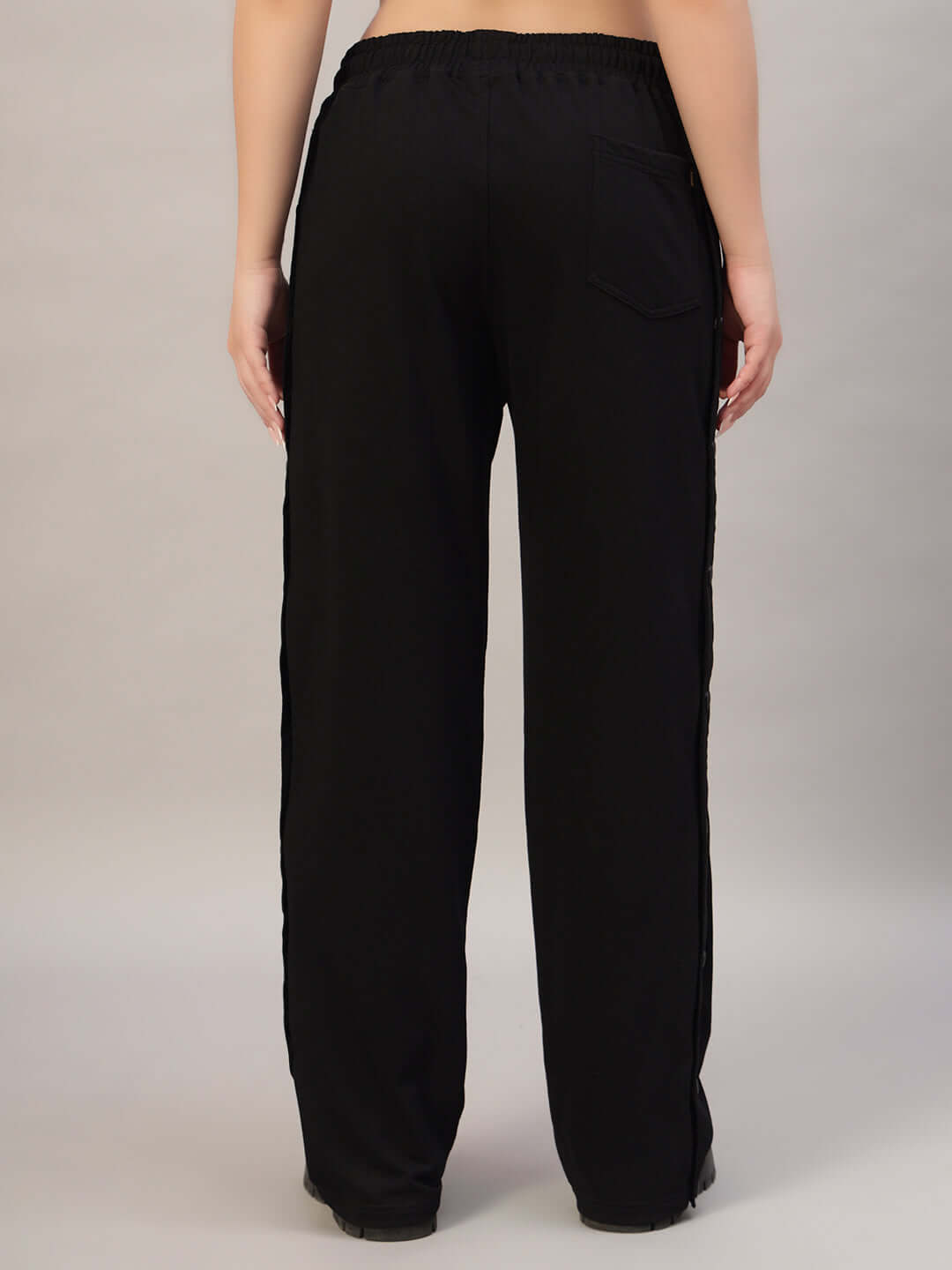 Rear view of women's black joggers by DUDS, showcasing an elastic waistband and comfortable fit. Perfect for casual wear.