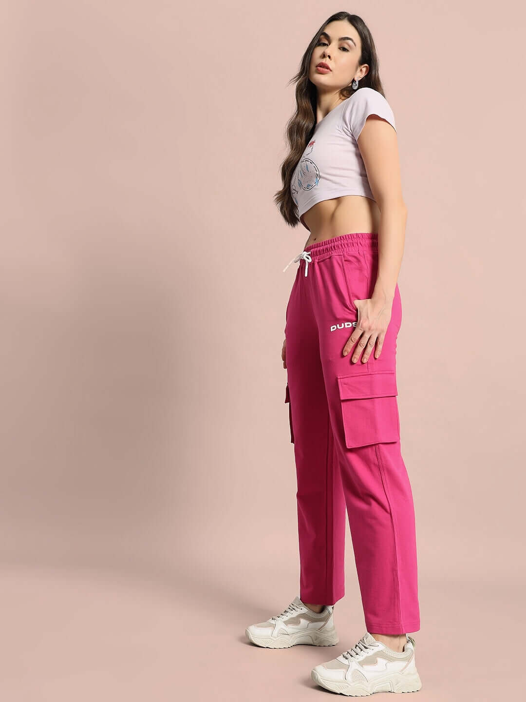 Woman wearing pink WOMEN'S MERRIAM JOGGERS, styled with a casual t-shirt and sneakers, showcasing comfortable fit and vibrant color.