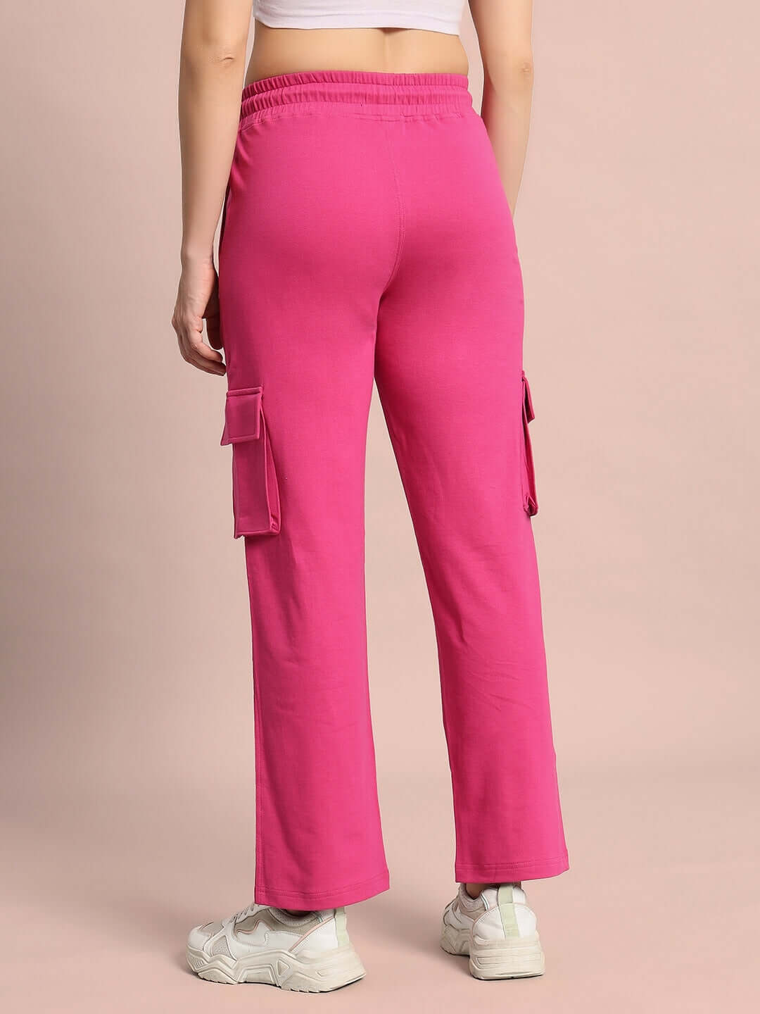 Back view of WOMEN'S MERRIAM JOGGERS in pink, showcasing cargo pockets and comfortable design, styled for everyday wear.