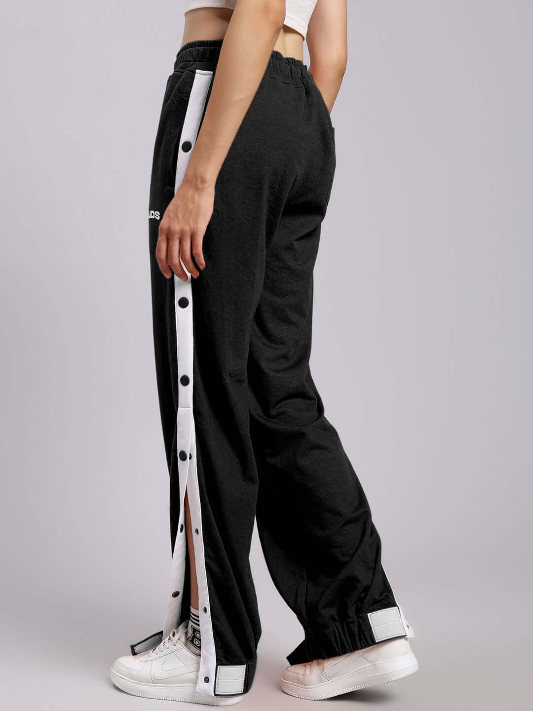 Model wearing Women's Miller Relaxed Fit Joggers in Black, featuring side buttons and a comfortable stretch waistband.