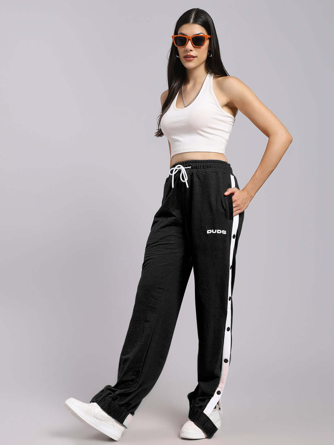 Model wearing women's black relaxed fit joggers and white top
