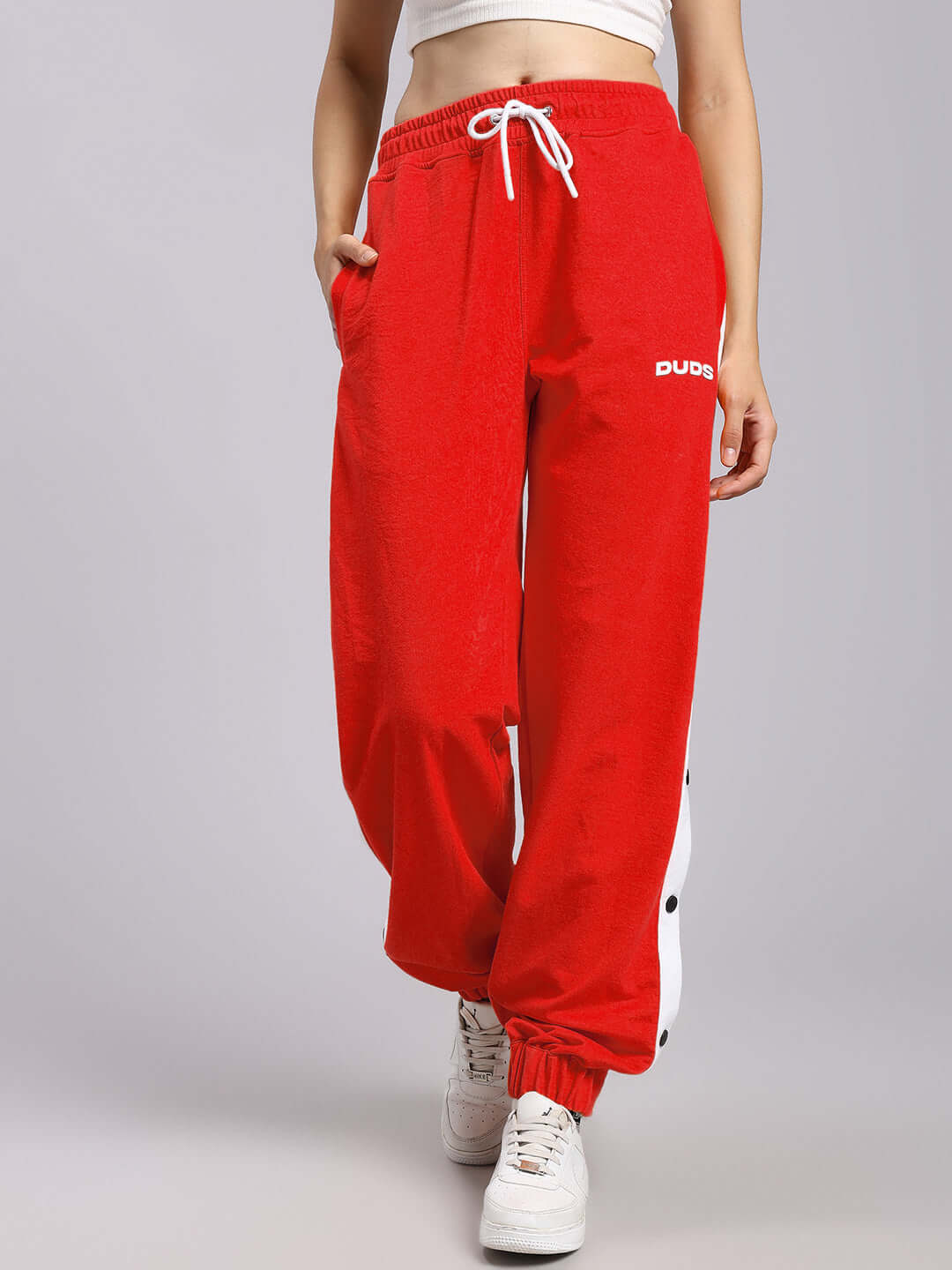Women's red relaxed fit joggers with drawstring waist, featuring casual style from DUDS.