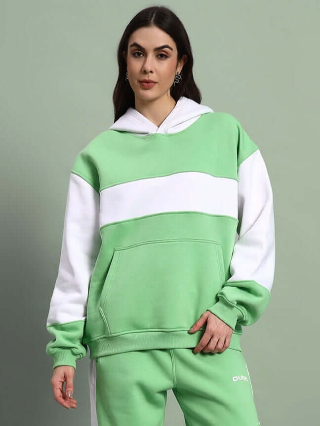 WOMEN MINTED BLISS FLEECE COLORBLOCK HOODIE GREEN WHITE worn by model, showcasing cozy streetwear style with bold colorblock design.