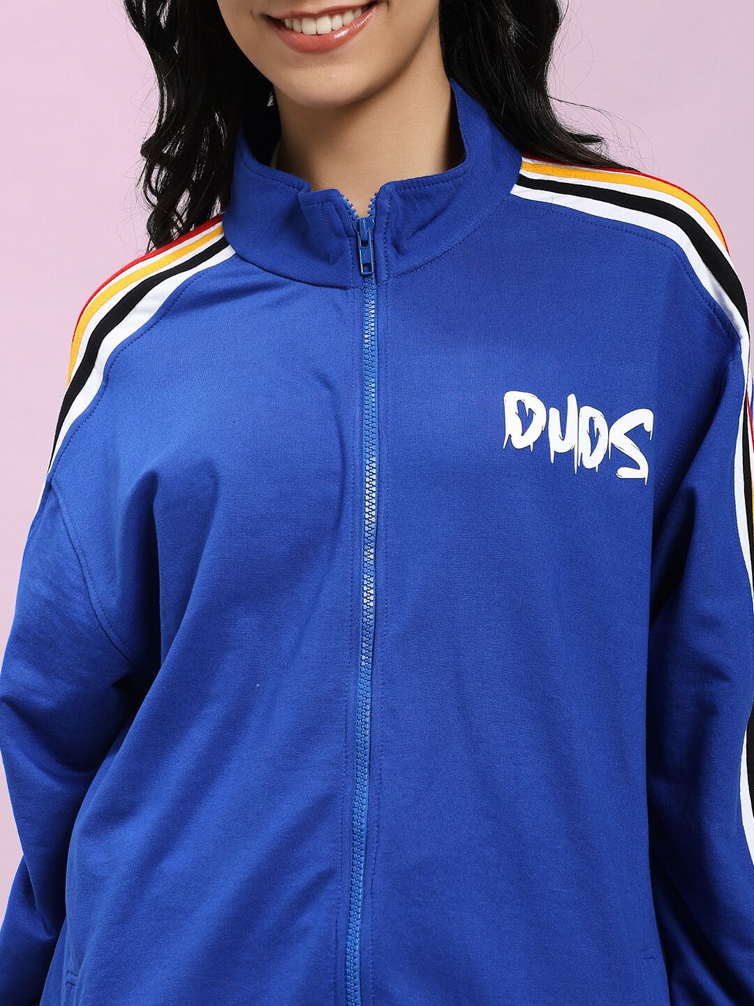 Close-up of woman wearing WOMEN MODERN EDGE MULTI-STRIPE CO-ORD SET ROYAL BLUE jacket with colorful stripes, showcasing stylish design.