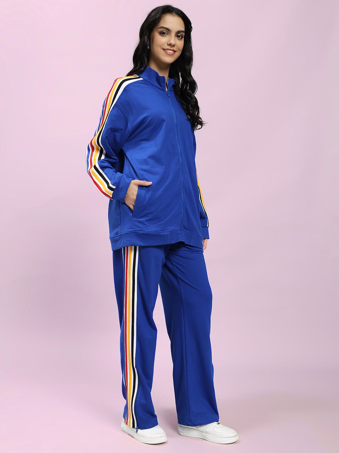 Woman wearing WOMEN MODERN EDGE MULTI-STRIPE CO-ORD SET ROYAL BLUE with sporty luxury style and multi-stripe accents.