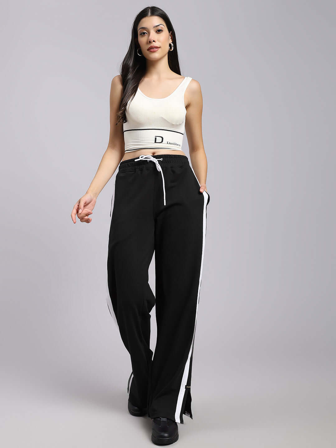 A woman wearing black Moscow Relaxed Fit Joggers by DUDS, showcasing a comfortable and stylish design.