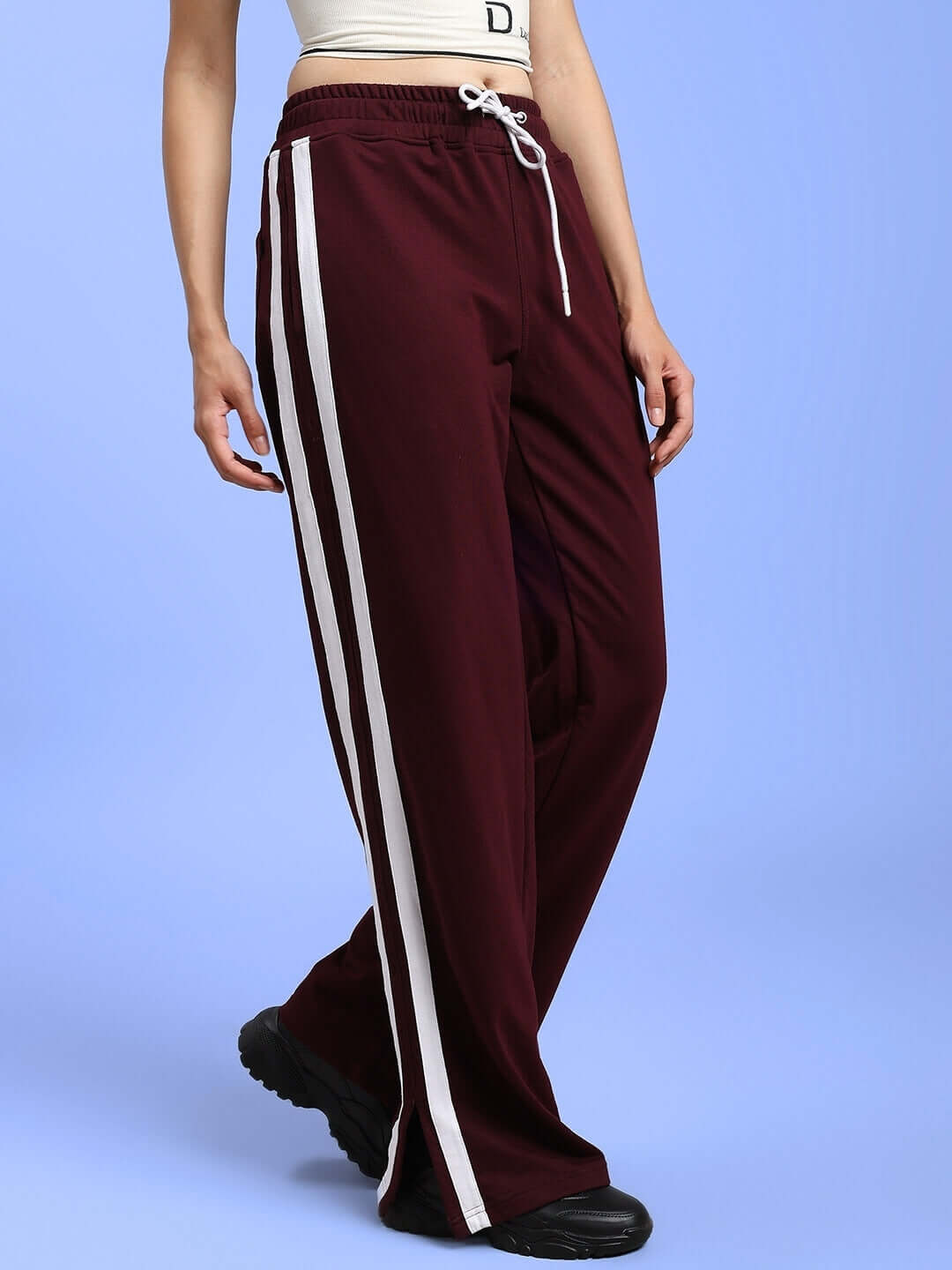 Women's maroon joggers with white side stripes, showcasing a relaxed fit perfect for comfort and style.