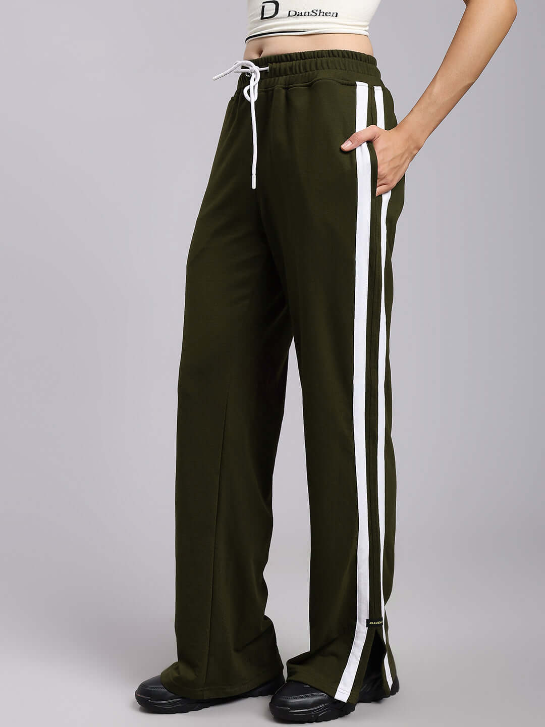 Olive green women's relaxed fit joggers with white side stripes, showcasing customizable made-to-order design by experienced tailors at DUDS.