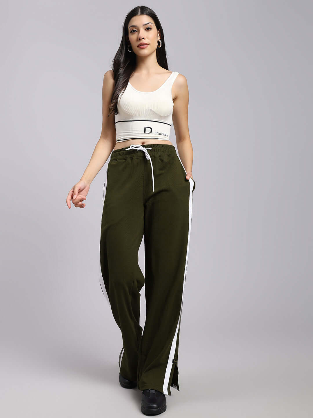 Model wearing Women's Moscow Relaxed Fit Joggers in Olive Green with white side stripes, stylish and comfortable for casual wear.