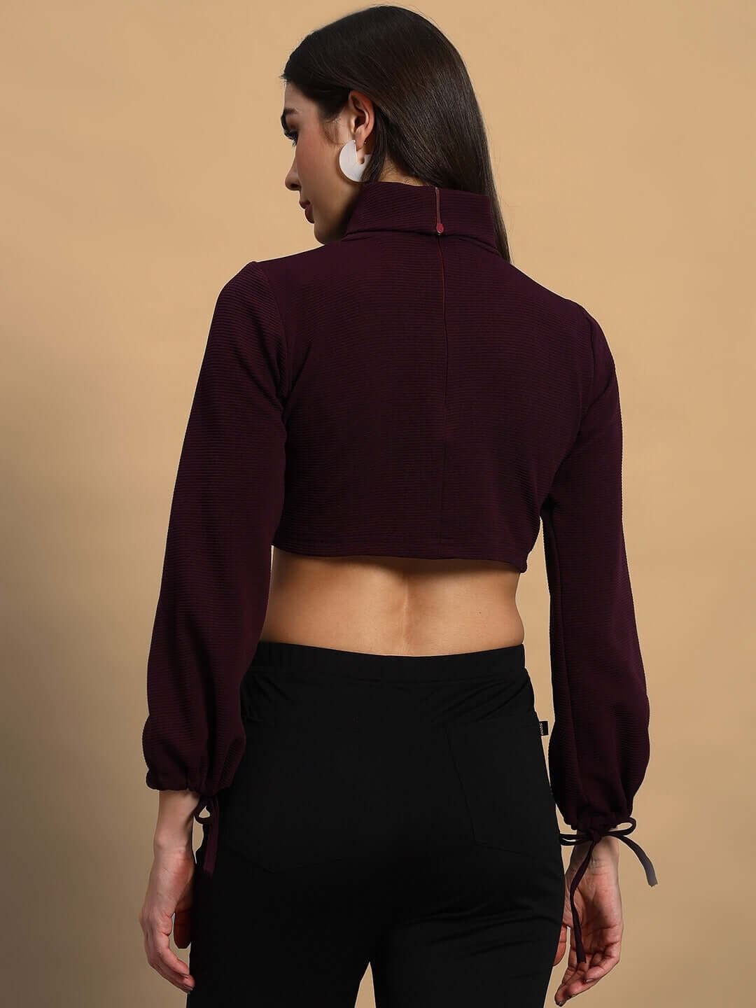 Back view of a woman wearing a wine-colored ribbed crop top made from premium Lycra fabric.