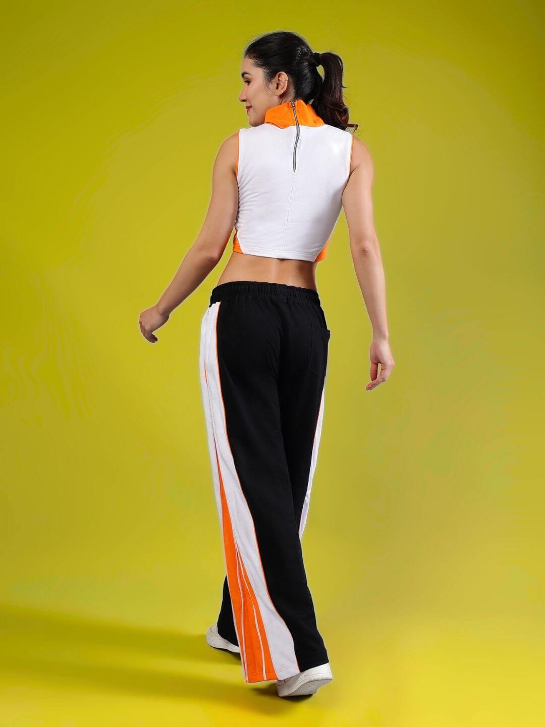 Model wearing WOMEN'S MYSKY CO-ORD SET WHITE BLACK ORANGE from WEAR DUDS, showing streetwear fashion with vibrant colors and comfort.