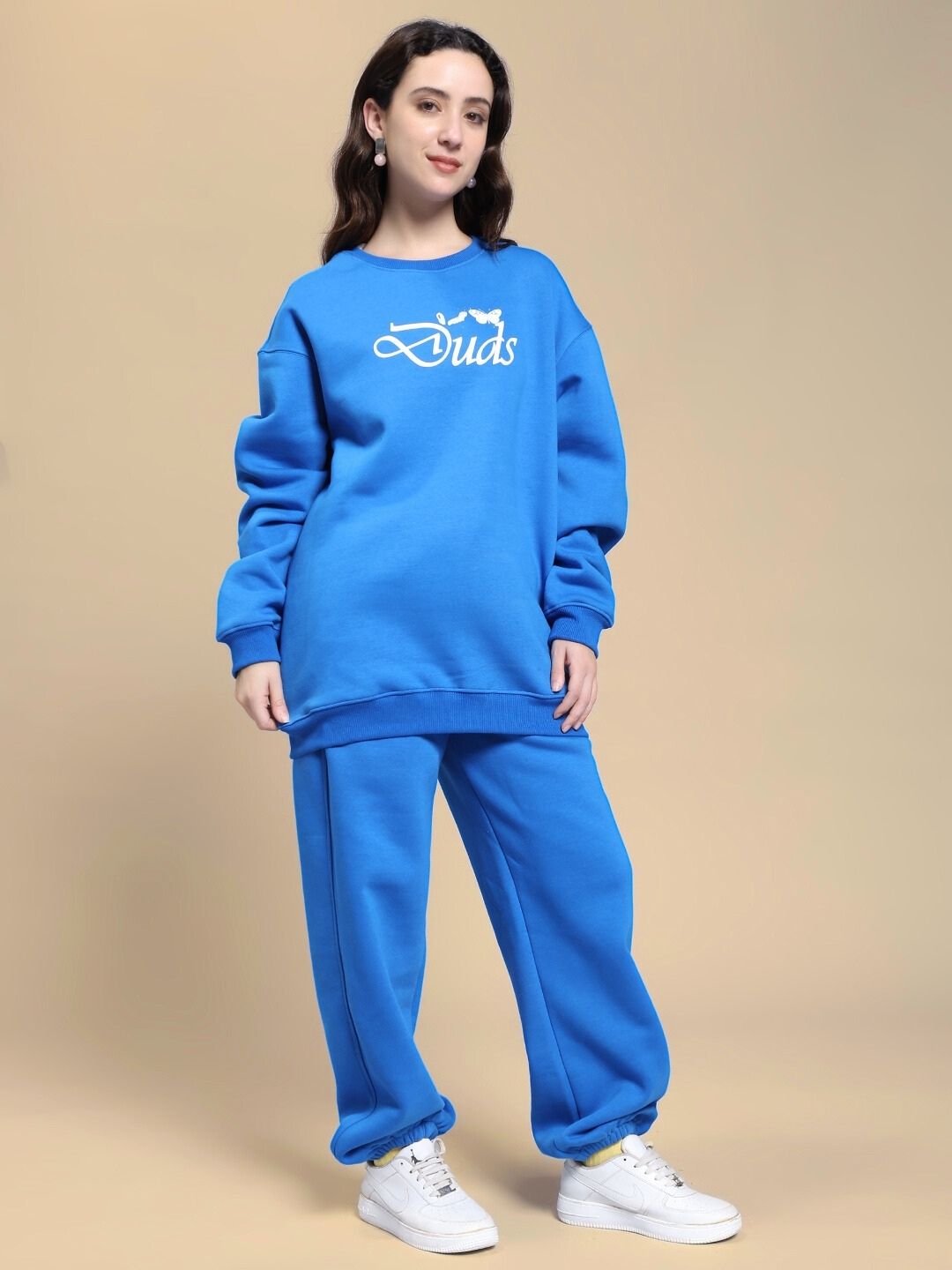 Woman wearing WOMEN NATURE LINK FLEECE CO-ORD SET ROYAL BLUE, featuring a cozy sweatshirt and joggers, standing against a neutral background.