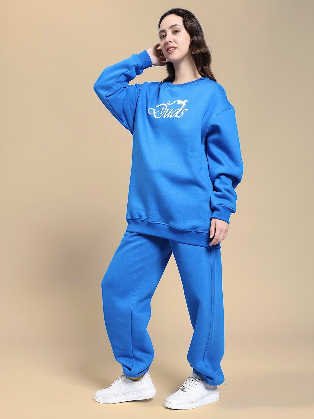 Woman wearing WOMEN NATURE LINK FLEECE CO-ORD SET ROYAL BLUE, stylish and cozy fleece outfit featuring sweatshirt and joggers for cooler days.