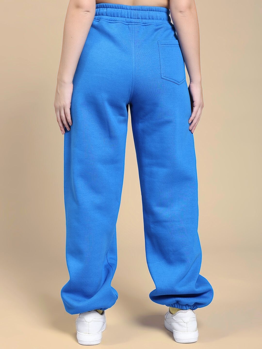 Back view of WOMEN'S NATURE LINK FLEECE JOGGER ROYAL BLUE showcasing relaxed fit and elastic cuffs.