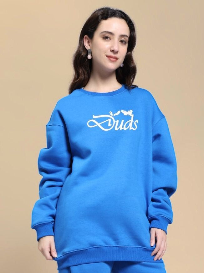 Woman modeling the WOMEN'S NATURE LINK FLEECE SWEATSHIRT ROYAL BLUE with a casual fit, perfect for stylish outdoor wear.