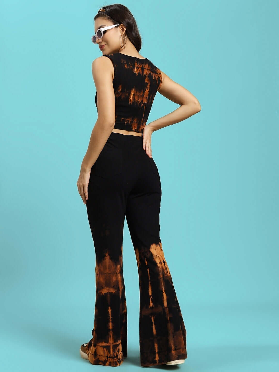 Model wearing WOMEN'S NINA Tie-Dye Co-Ord Set in black, featuring a stylish tank top and flared joggers, made of cotton fabric.