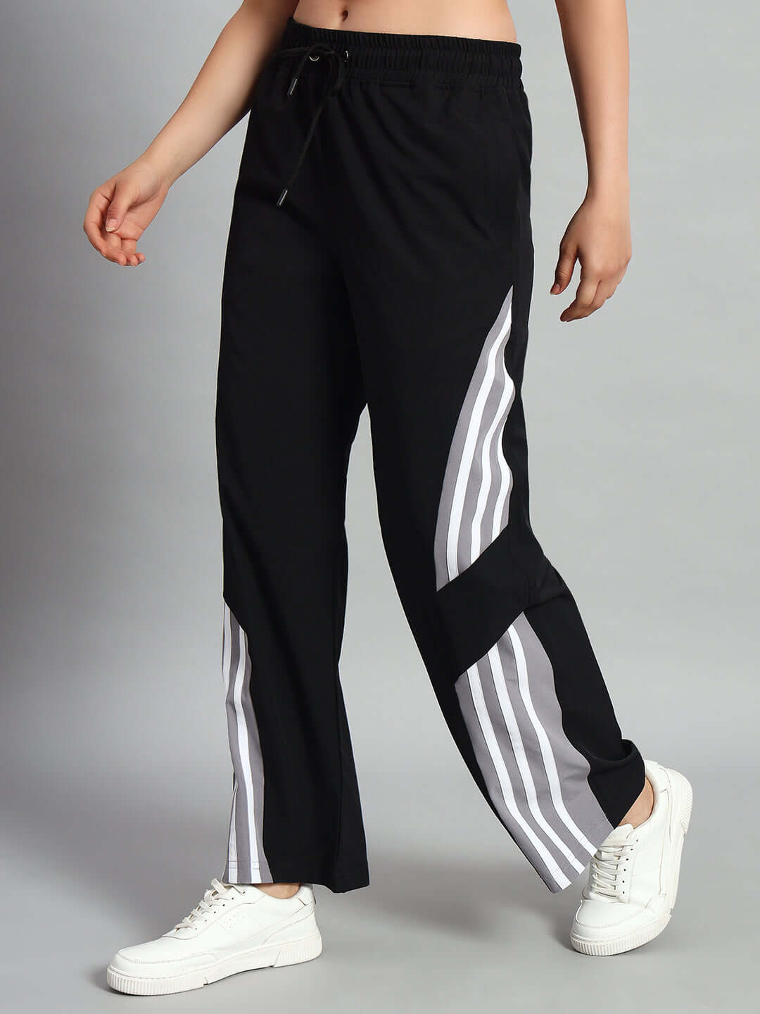 Women's black relaxed fit cargo pants with white stripes, customizable sizing available. Ideal for casual wear with a comfortable fit.