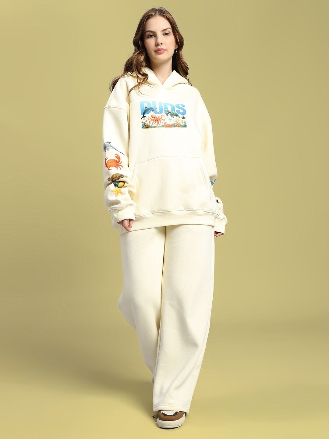 Model wearing WOMEN'S OCEAN BUDDIES FLEECE CO-ORD SET OFF-WHITE with sea-inspired graphics