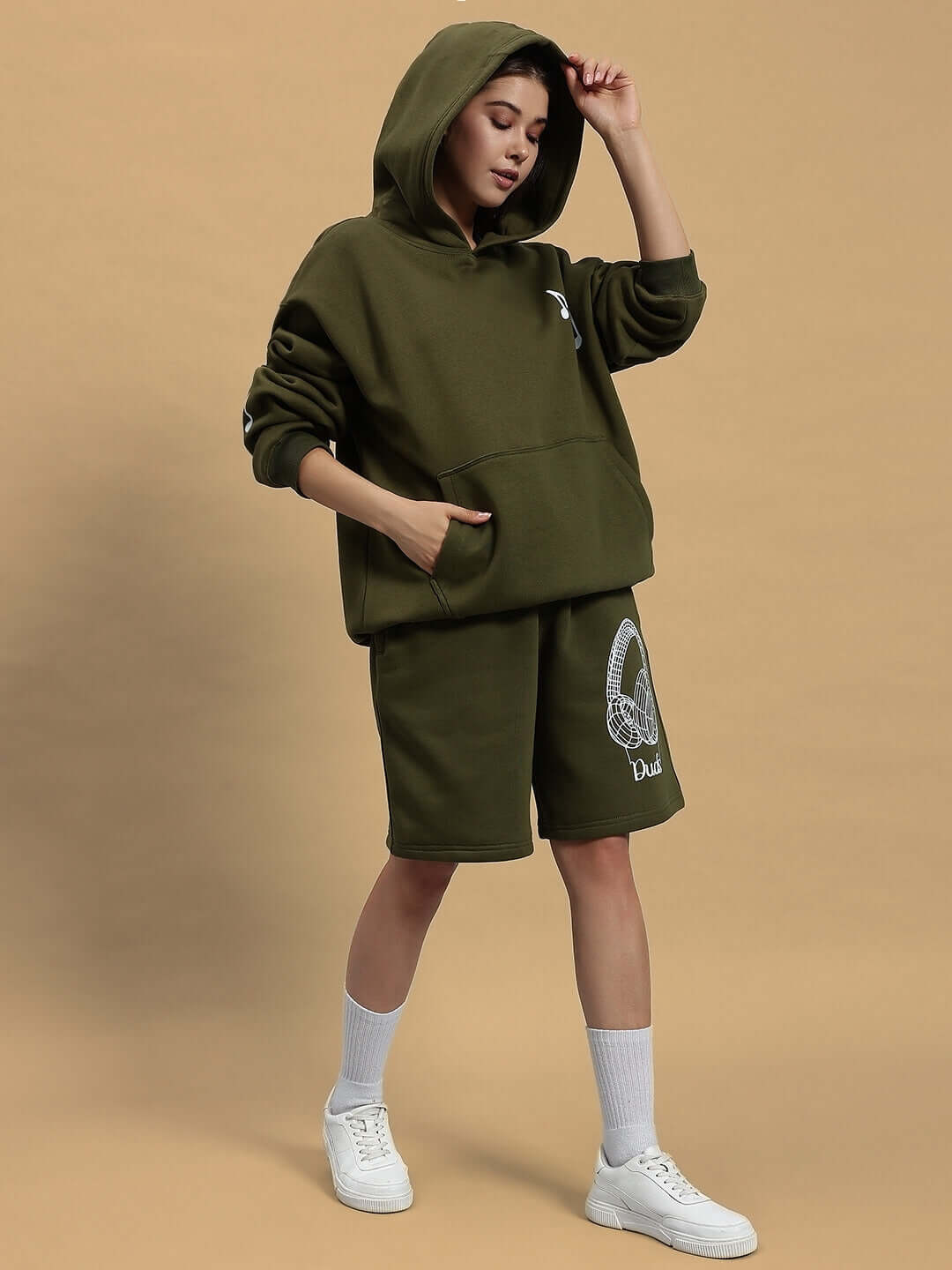 Model wearing WOMEN OPERA FLEECE CO-ORD OLIVE GREEN set, showcasing the stylish hoodie and shorts ensemble.