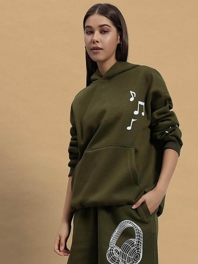 Woman wearing WOMEN OPERA FLEECE HOODIE OLIVE GREEN with musical note design.