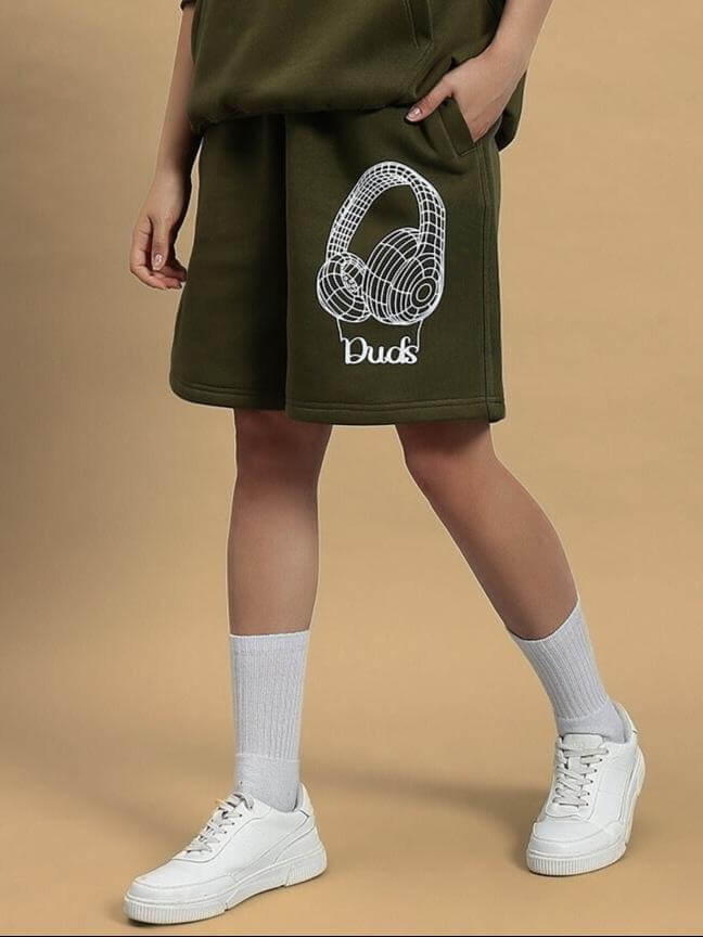 Model wearing WOMEN OPERA FLEECE SHORTS OLIVE GREEN with headphone design, showcasing casual style and comfort.