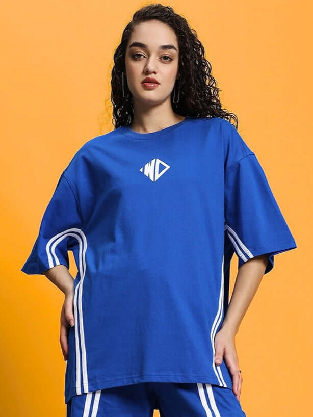 Model wearing WOMEN'S OUTLOOK Over-sized T-shirt in Royal Blue featuring white stripes, made from premium cotton French Terry, 220 GSM, 97% cotton.