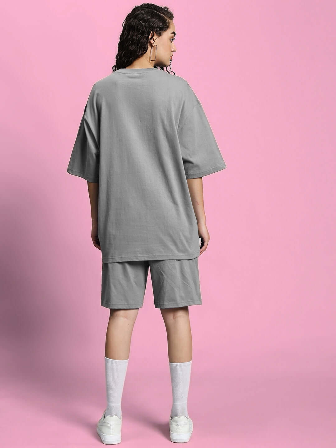 Back view of WOMEN'S OUTLOOK SUMMER CO-ORD SHORTS SET GREY showcasing comfort and style on a pink background.