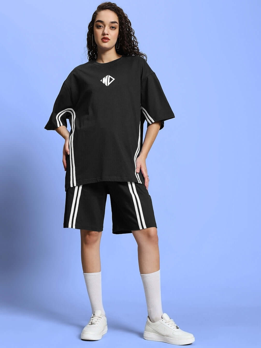 Model wearing WOMEN'S OUTLOOK SUMMER CO-ORD SHORTS SET BLACK against blue background