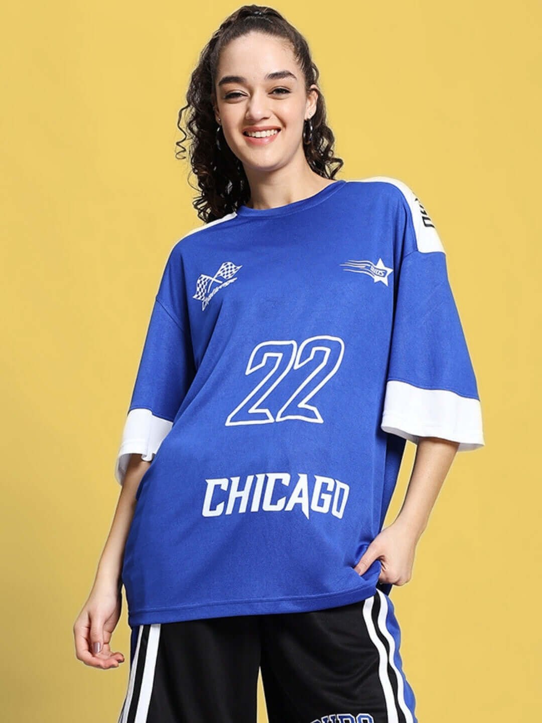 Woman wearing oversized royal blue Chicago t-shirt with number 22, showcasing custom fit and comfort.