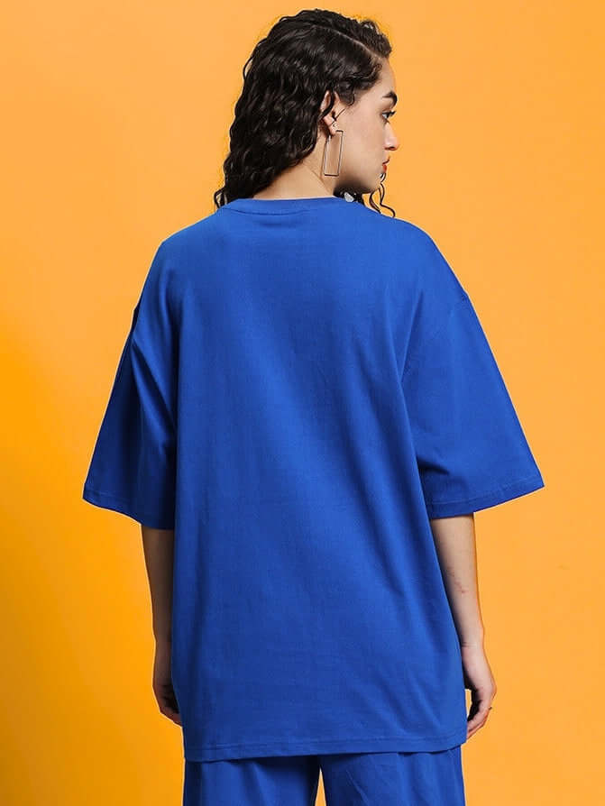 Back view of women's oversized blue t-shirt in premium cotton fabric, perfect for casual wear. Made in India. Cold machine wash recommended.
