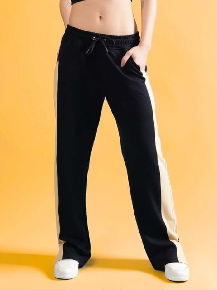 Stylish Women's Paradise Side Slit Joggers in black and beige with custom fit option by DUDS, model wearing casual fashion.