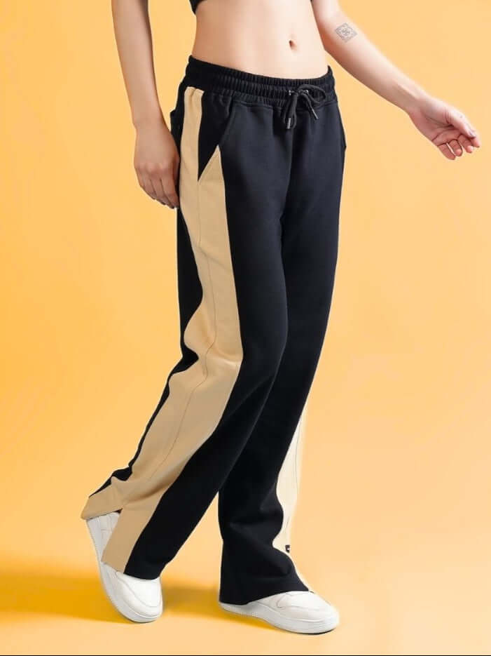 Woman wearing DUDS Women's Paradise Side Slit Joggers in Black-Beige, made-to-order.