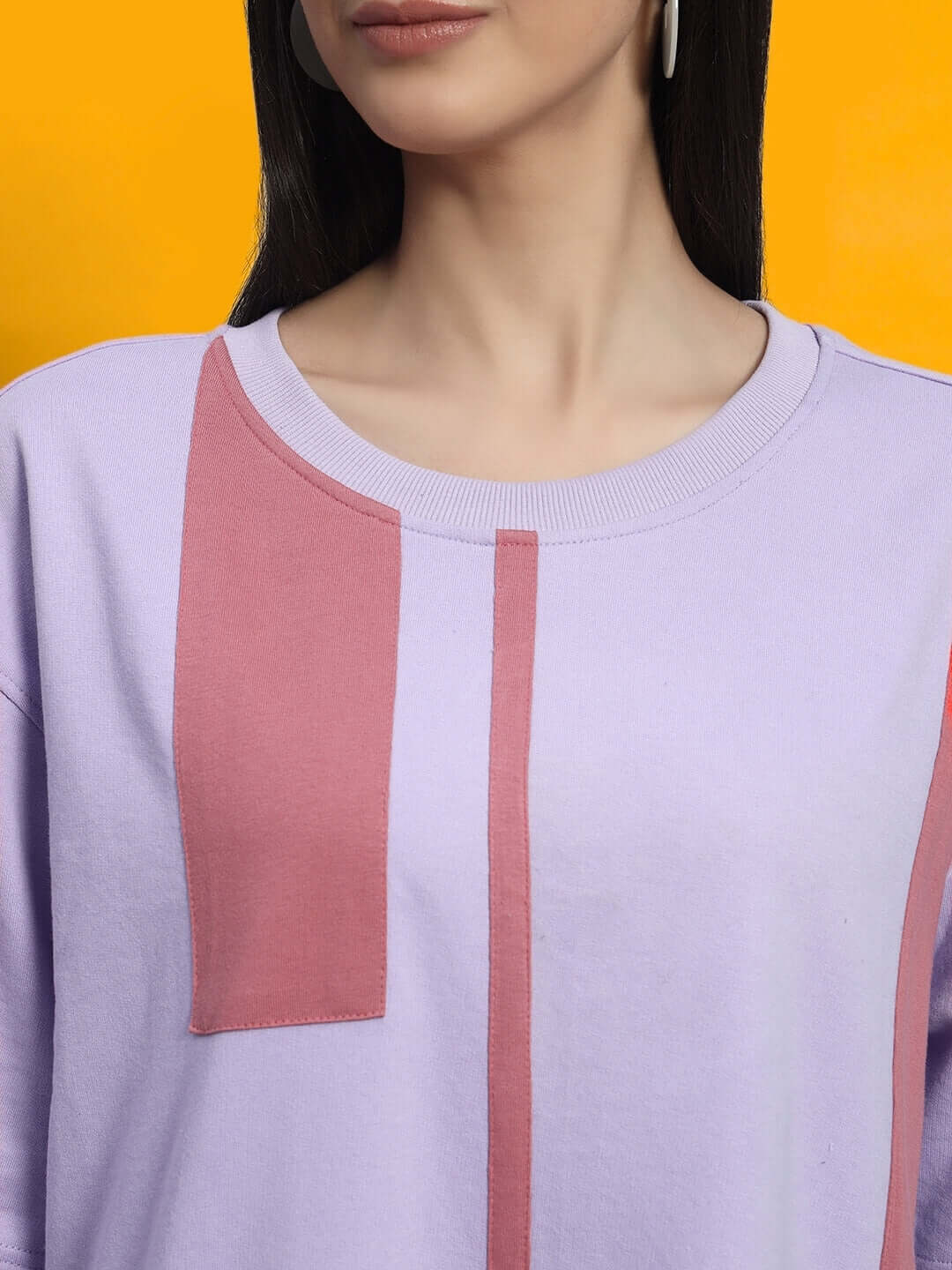 Model wearing WOMEN'S PEACH PUFF DRESS LILAC with soft puff sleeves and lilac shade on vibrant orange background.