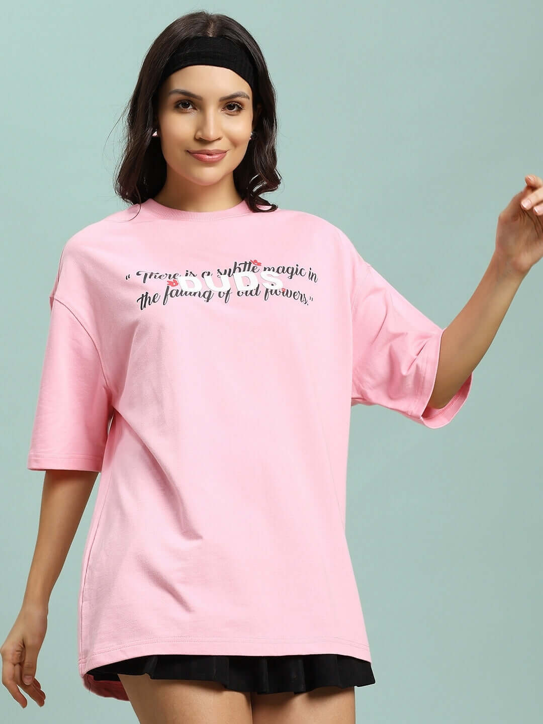 Model wearing Women's Falling Flower T-Shirt in pink, made from premium cotton French terry and elastane, designed by Color By Colours.