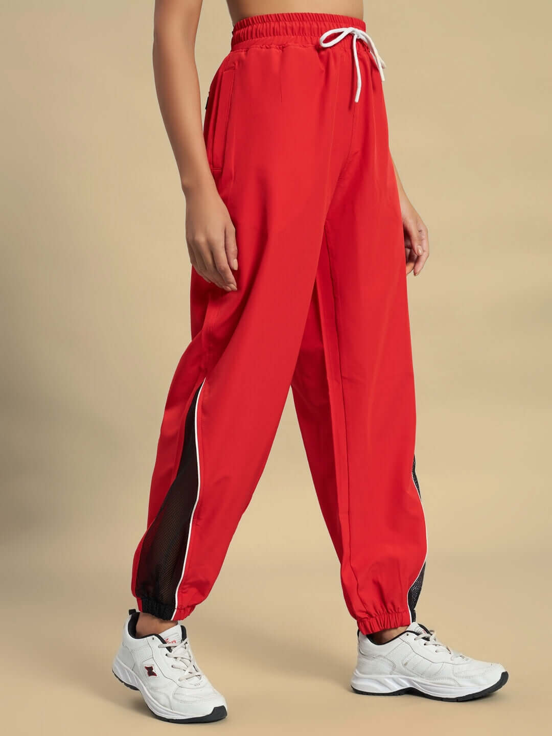 Women's red Plexus joggers by DUDS, elastic waistband, black stripe, customizable size, made by skilled tailors, sporty and stylish.