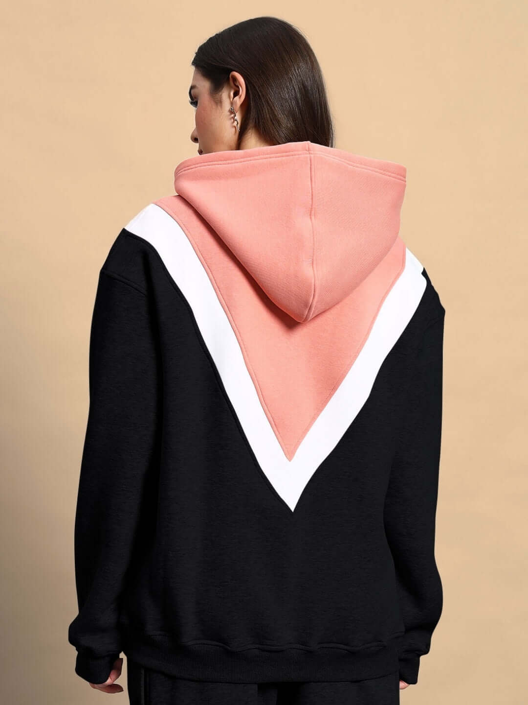 Back view of WOMEN POLAR COLORBLOCK HOODIE BLACK PEACH with bold black and peach design.