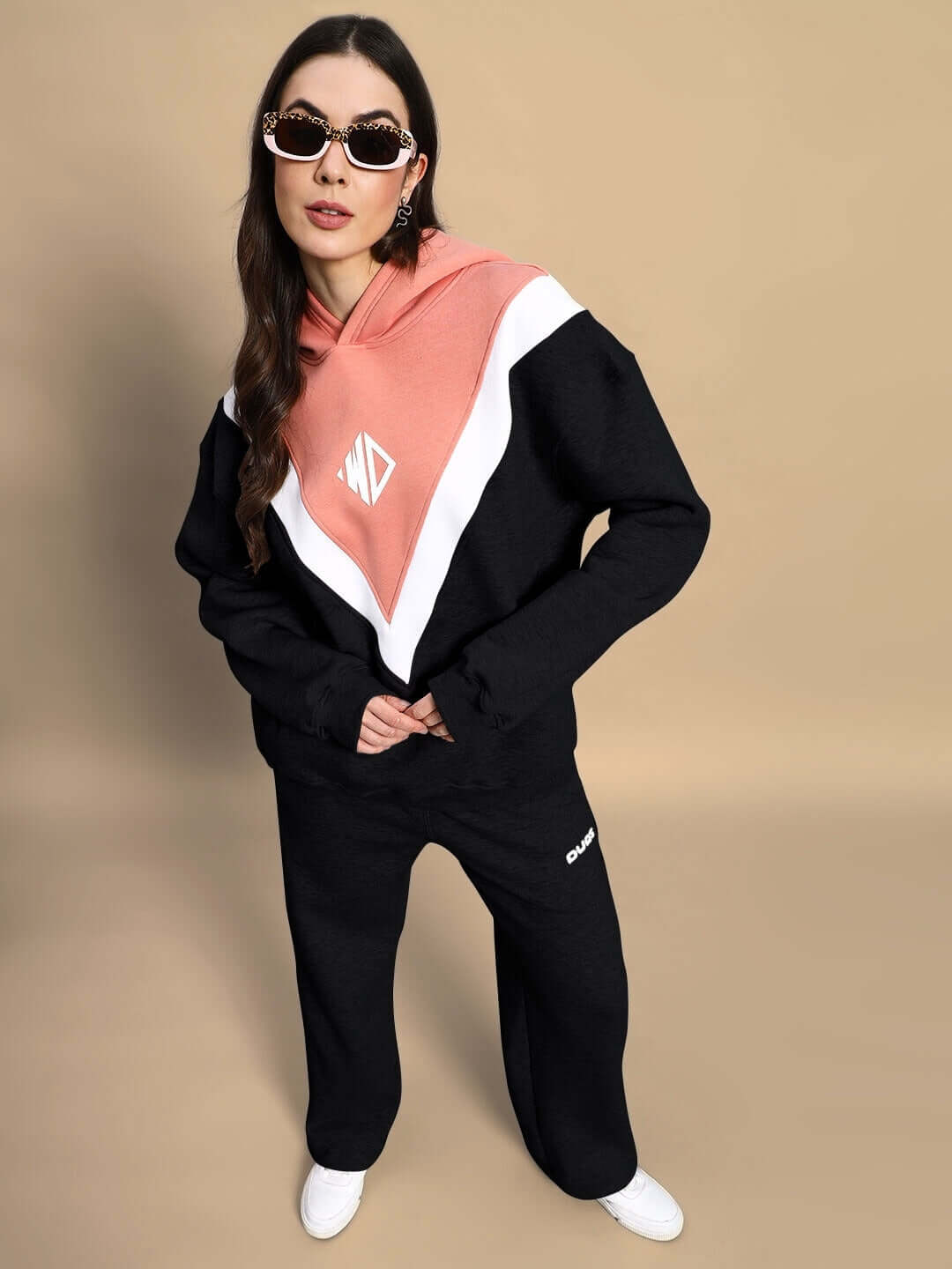 alt_tag: Stylish model wearing WOMEN POLAR COLORBLOCK HOODIE BLACK PEACH with bold colorblock design, perfect for chilly days.