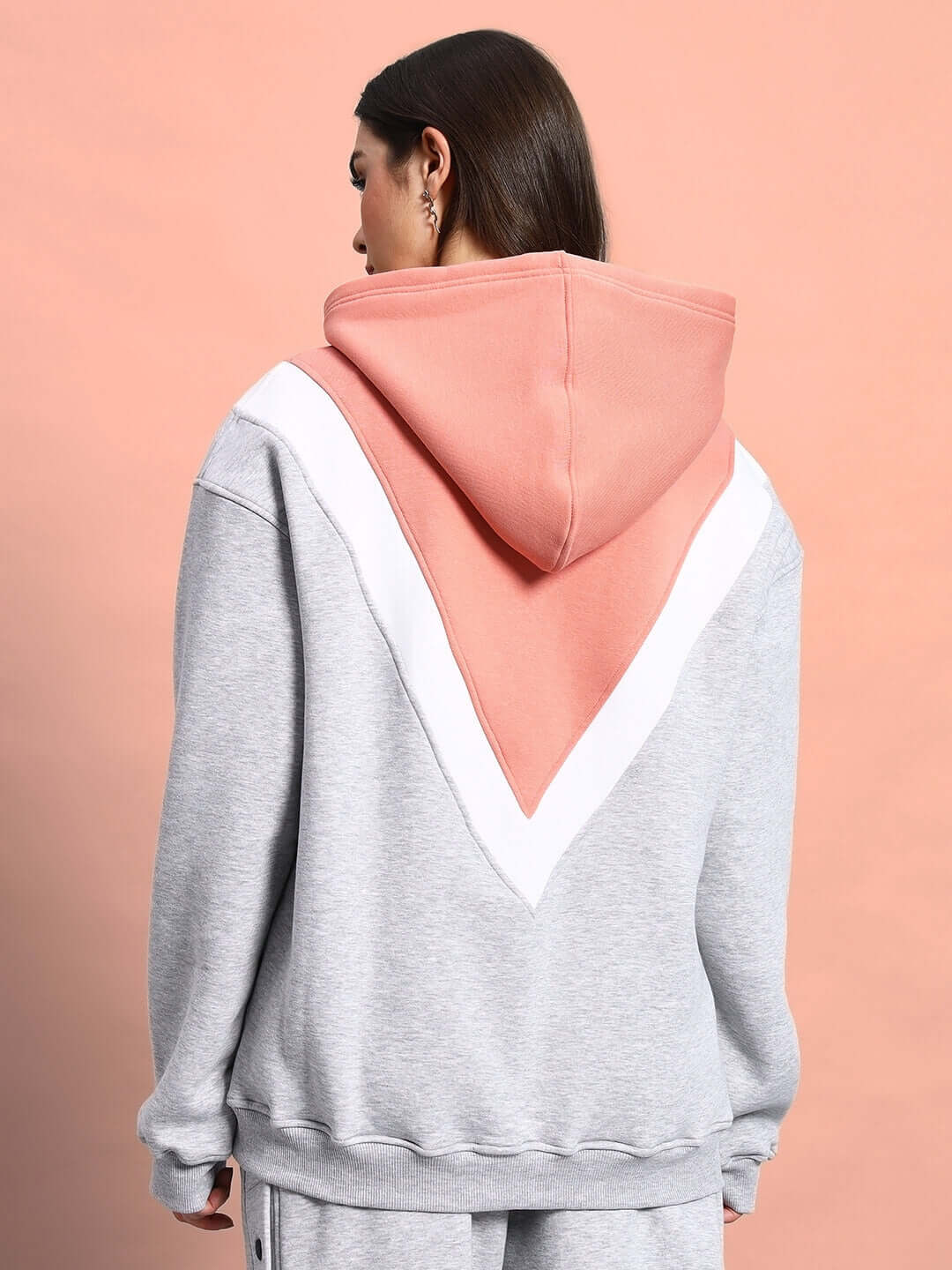 Back view of WOMEN POLAR COLORBLOCK HOODIE GREY PEACH with grey and peach colorblock design, showcasing trendy style and premium fleece fabric.