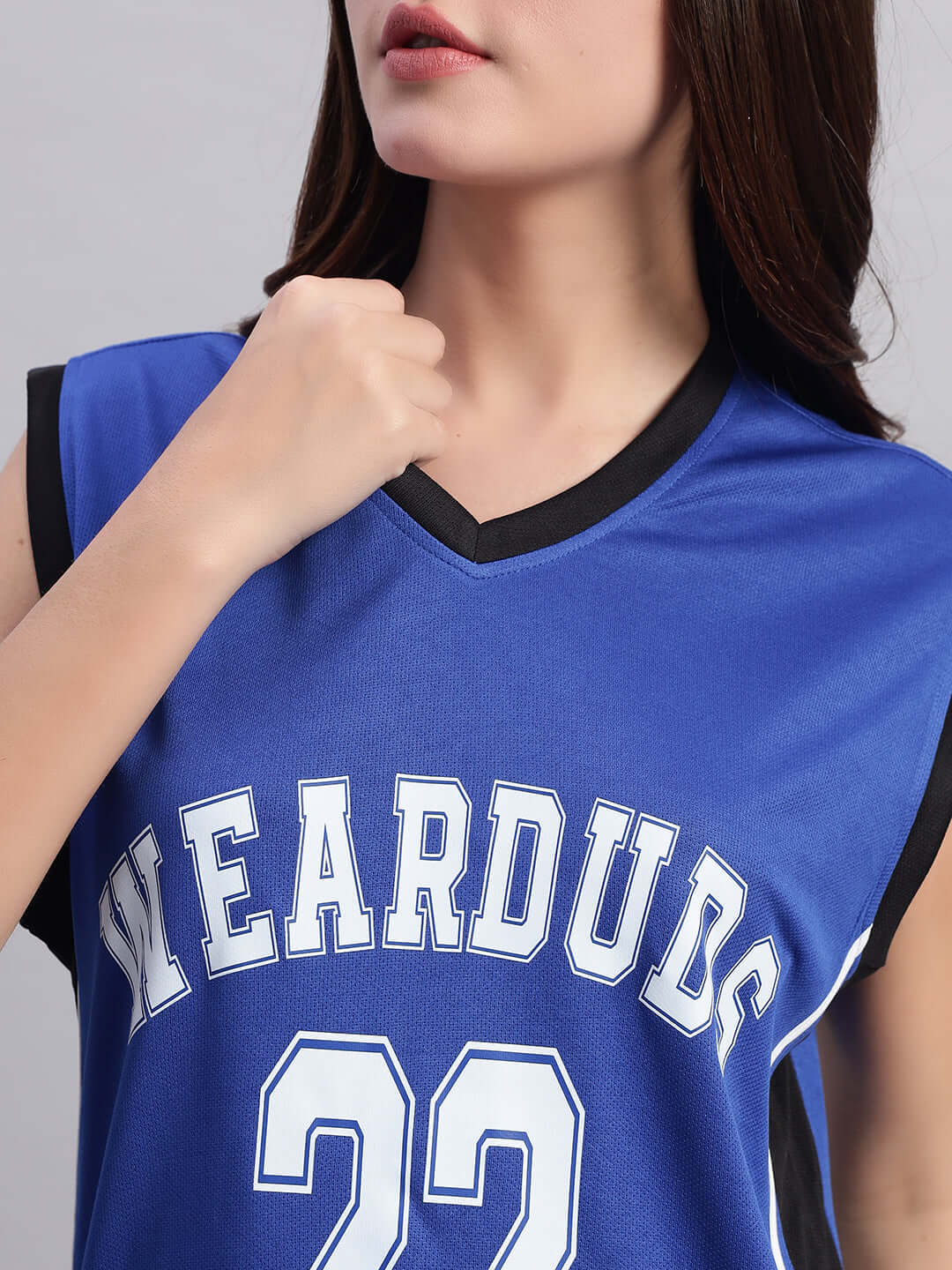 Woman wearing DUDS royal blue Portia gym T-shirt with 'WEARDUDS' and '22' printed, displaying stylish athletic wear.